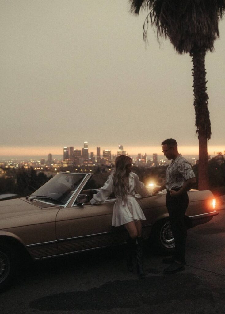 luxury and classic couple in LA LOs Angeles with red car infrot of city view marry club vip
