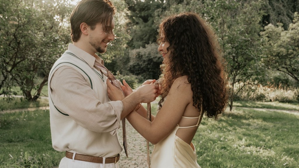 condomless sex decision: a couple embracing in a sunlit summer garden
