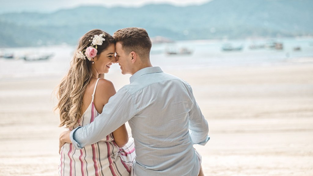 Couple on a sunny beach touching foreheads, a calm and respectful moment when two people end a relationship respectfully