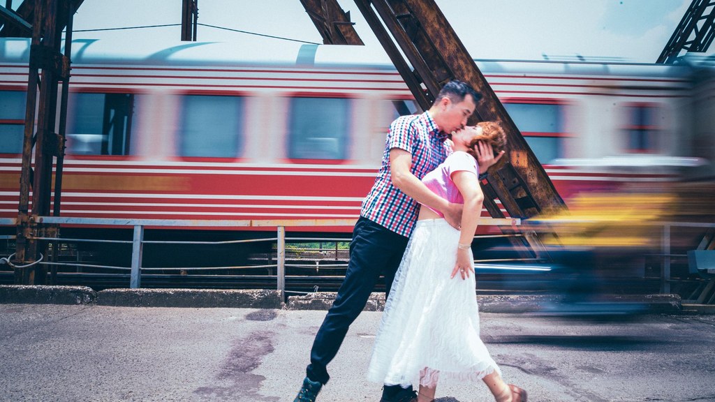 Couple kissing on a sunny train platform; intimacy in age gap relationships